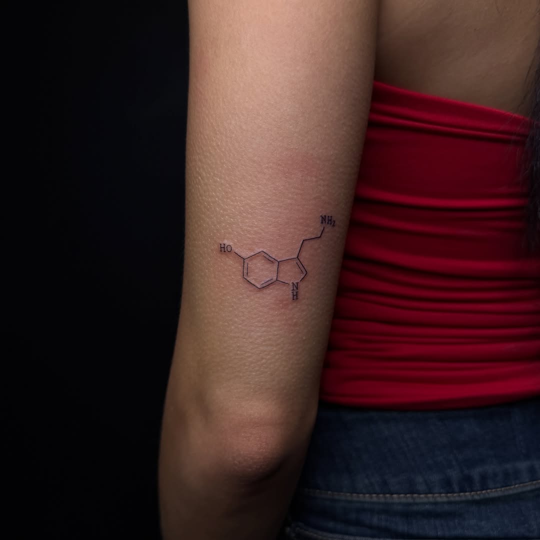 Serotonin molecule minimalist tattoo on the forearm by Pretty Ugly Tattoos