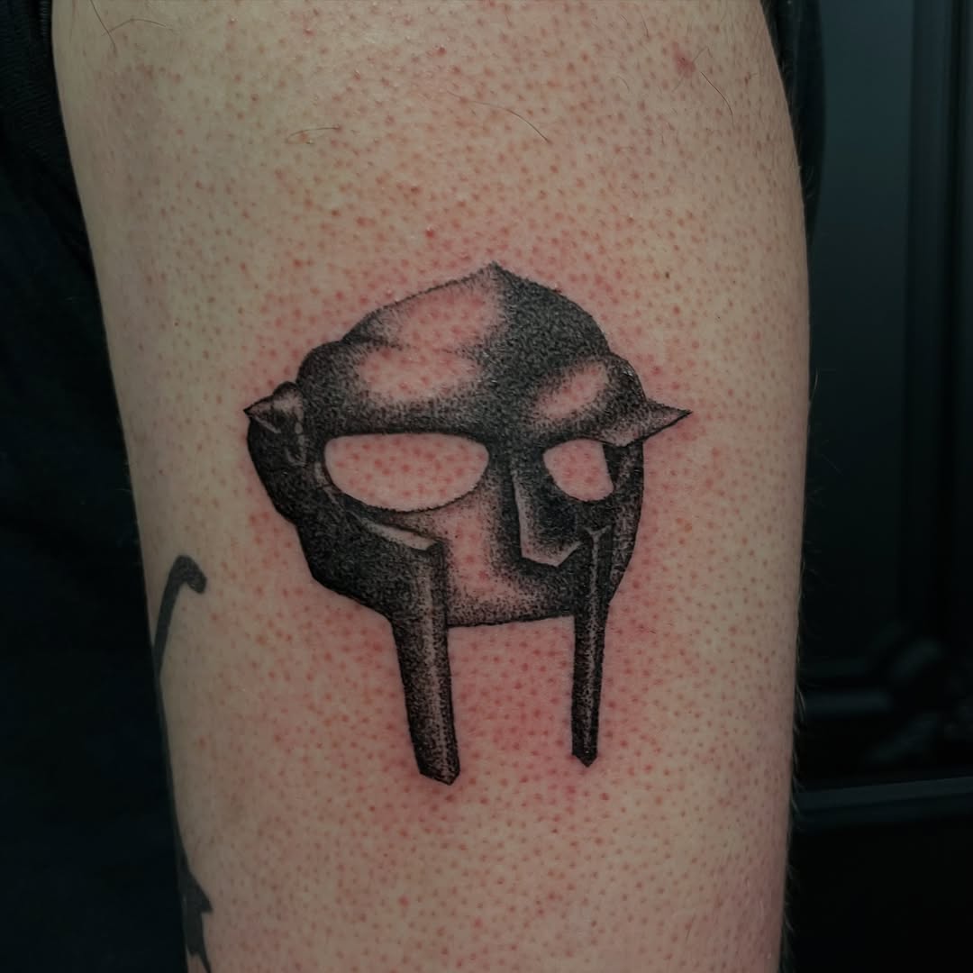MF Doom mask dark art tattoo on the forearm by ⁎⁺˳✧༚Emma