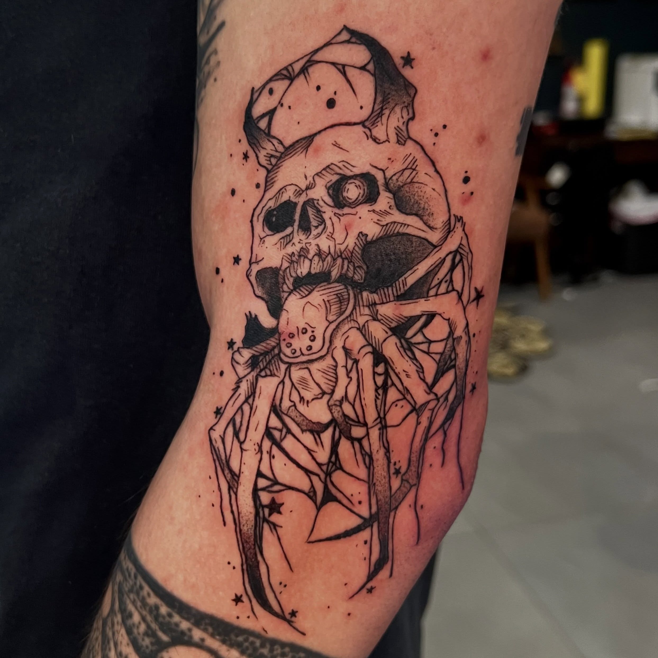 Skull and spider dark realism tattoo on the forearm by Nikki Malfitano