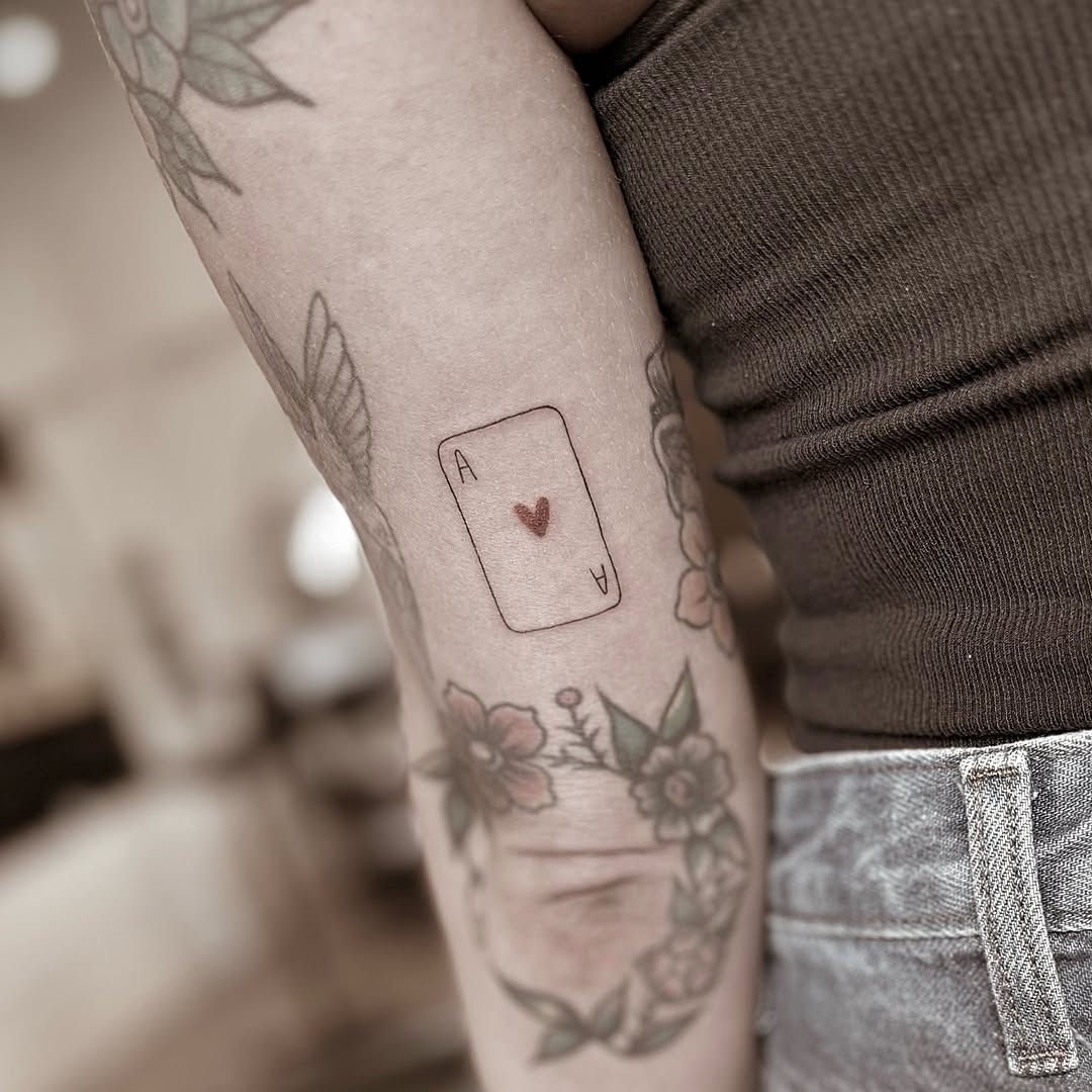 Ace of hearts card minimalist tattoo on the forearm by Chanel Picquelle, Nashville, Tennessee