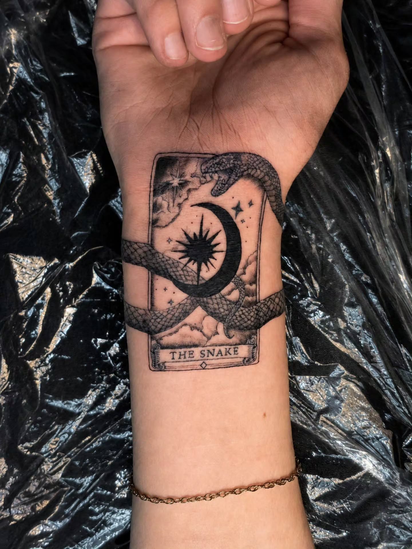 The snake black and grey tattoo on the forearm by 𝕷𝖚𝖈𝖎𝖉