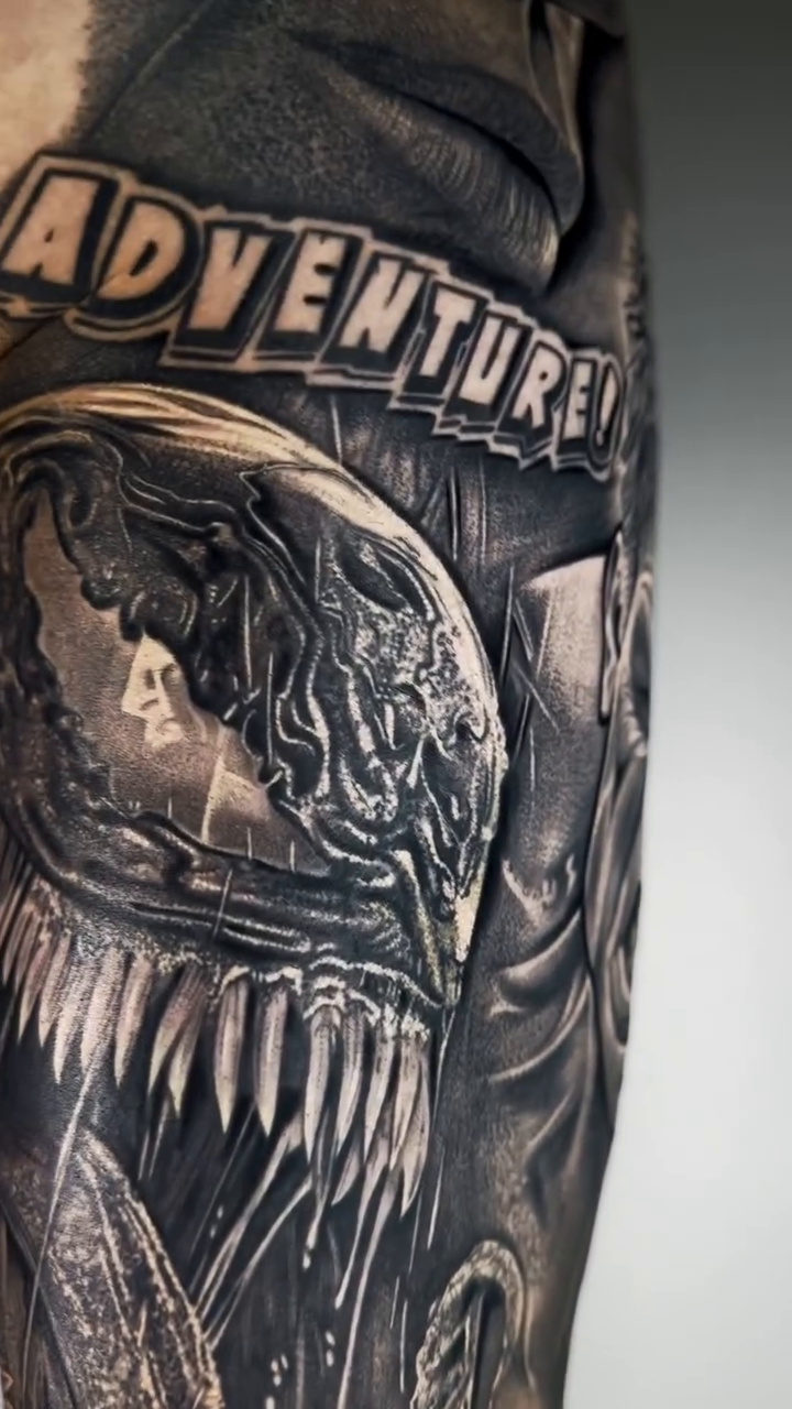 Venom portrait with teeth and tongue dark art tattoo on the forearm by Mak$ Brand