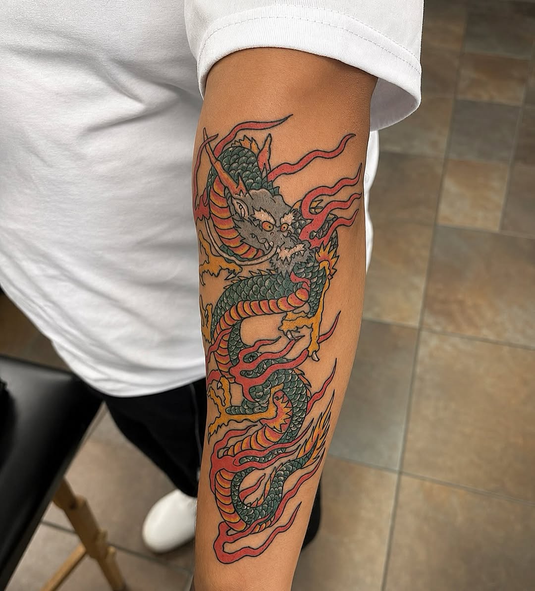 Dragon with flames Japanese tattoo on the forearm by Stoney