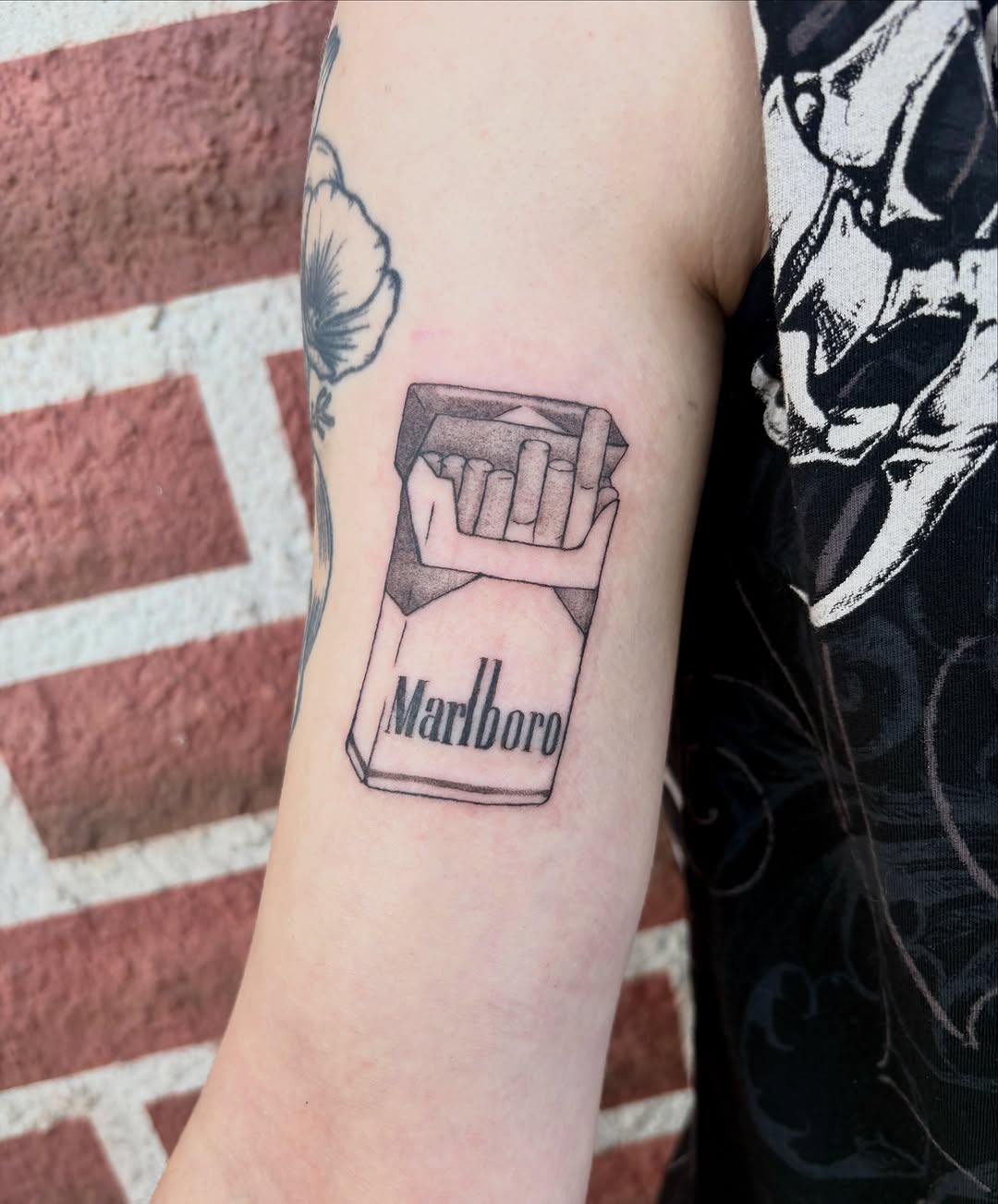 Pack of cigarettes minimalist tattoo on the forearm by izzy solae