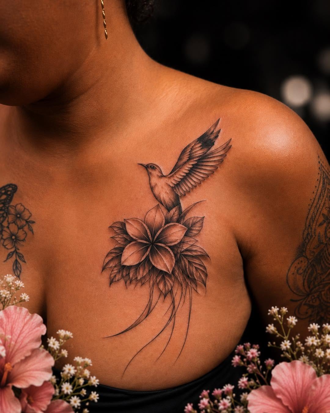 Hummingbird and flower fine line tattoo on the chest by Flamboyant