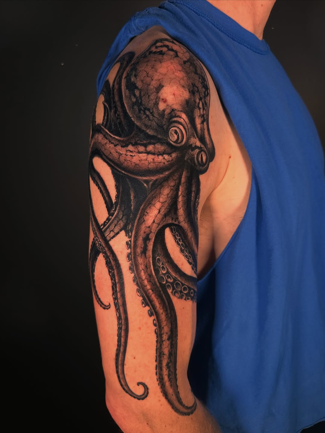 Octopus realism tattoo on the upper arm by Shihao zhao