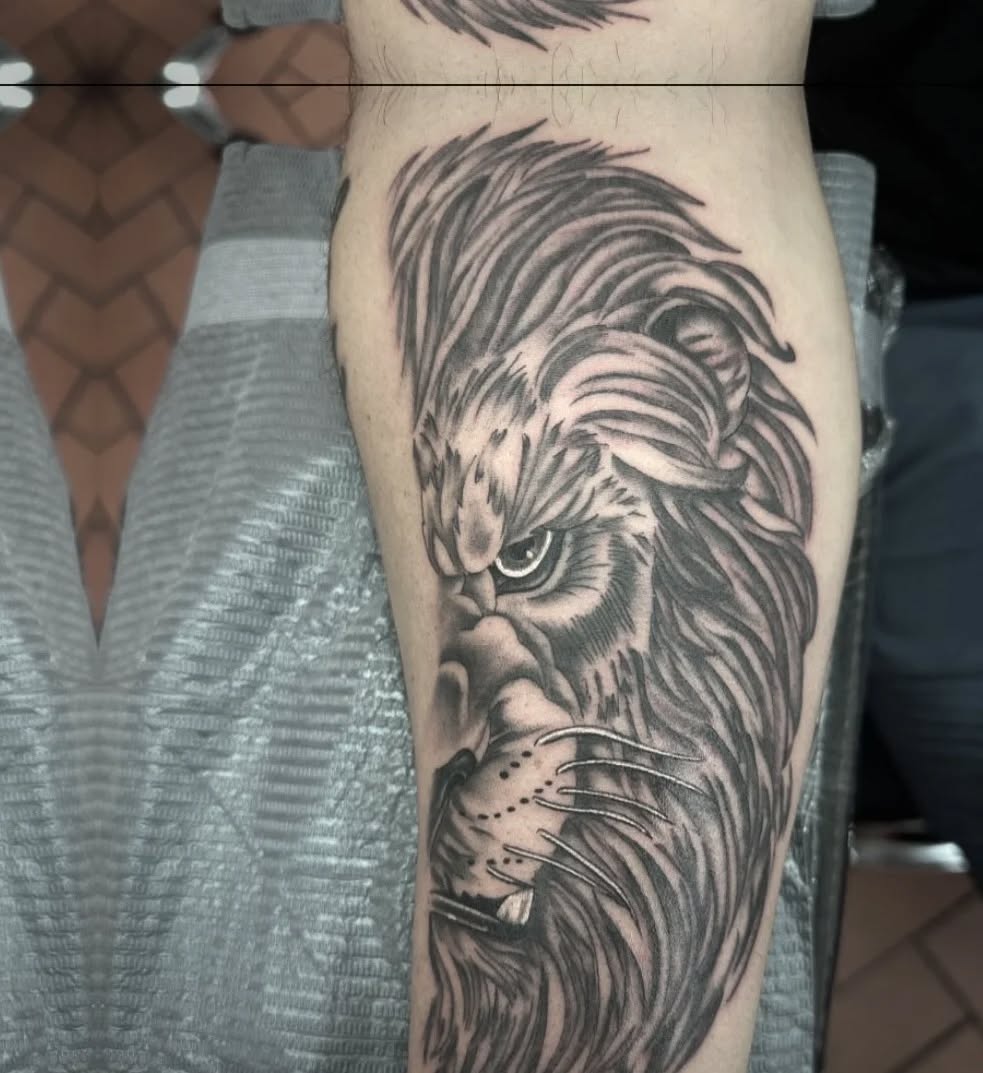 Lion portrait realism tattoo on the forearm by Greyson Heidenreich