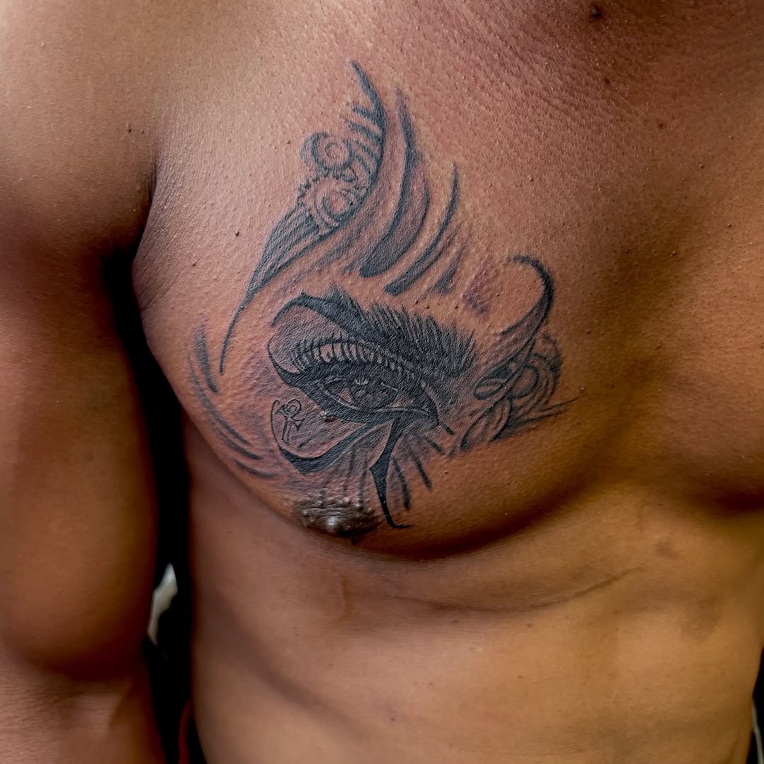 Egyptian eye with flames tribal tattoo on the chest by Still Standing. Still Creating. 🖤
