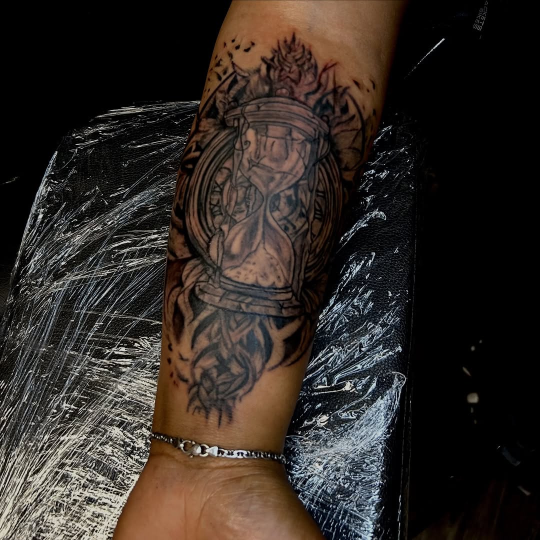 Hourglass and clock surrealism tattoo on the forearm by Still Standing. Still Creating. 🖤