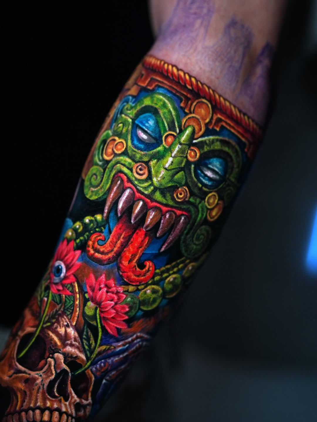 Aztec mask and skull with flowers neo-traditional tattoo on the forearm by Alberto M