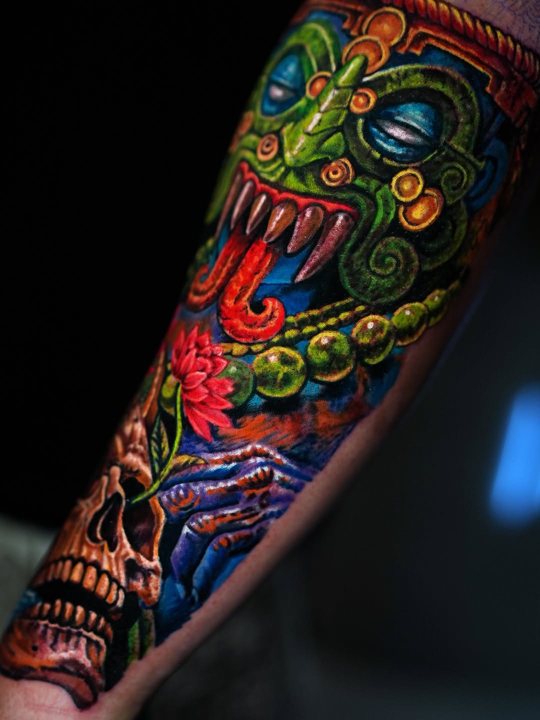 Aztec mask and skull surrealism tattoo on the forearm by Alberto M