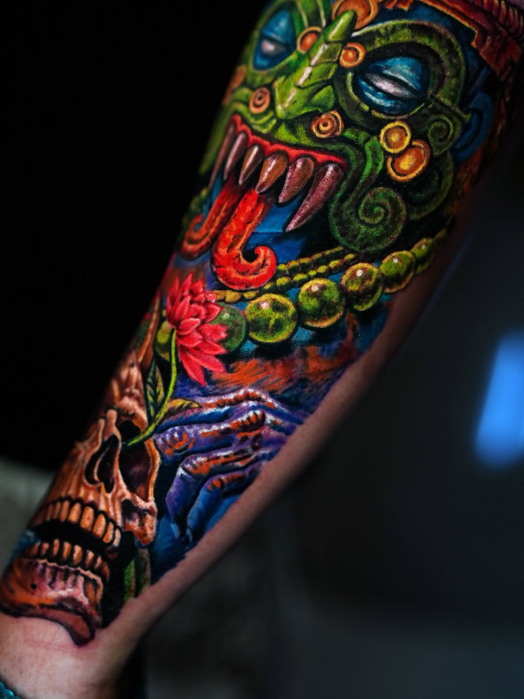 Aztec mask and skull surrealism tattoo on the forearm by Alberto Marrero