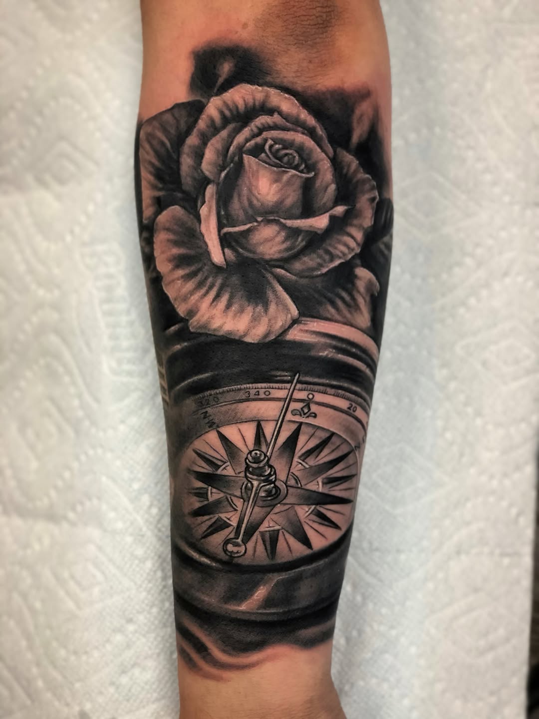 Rose and compass dotwork tattoo on the forearm by Daniel Fisher, Berlin, New Jersey