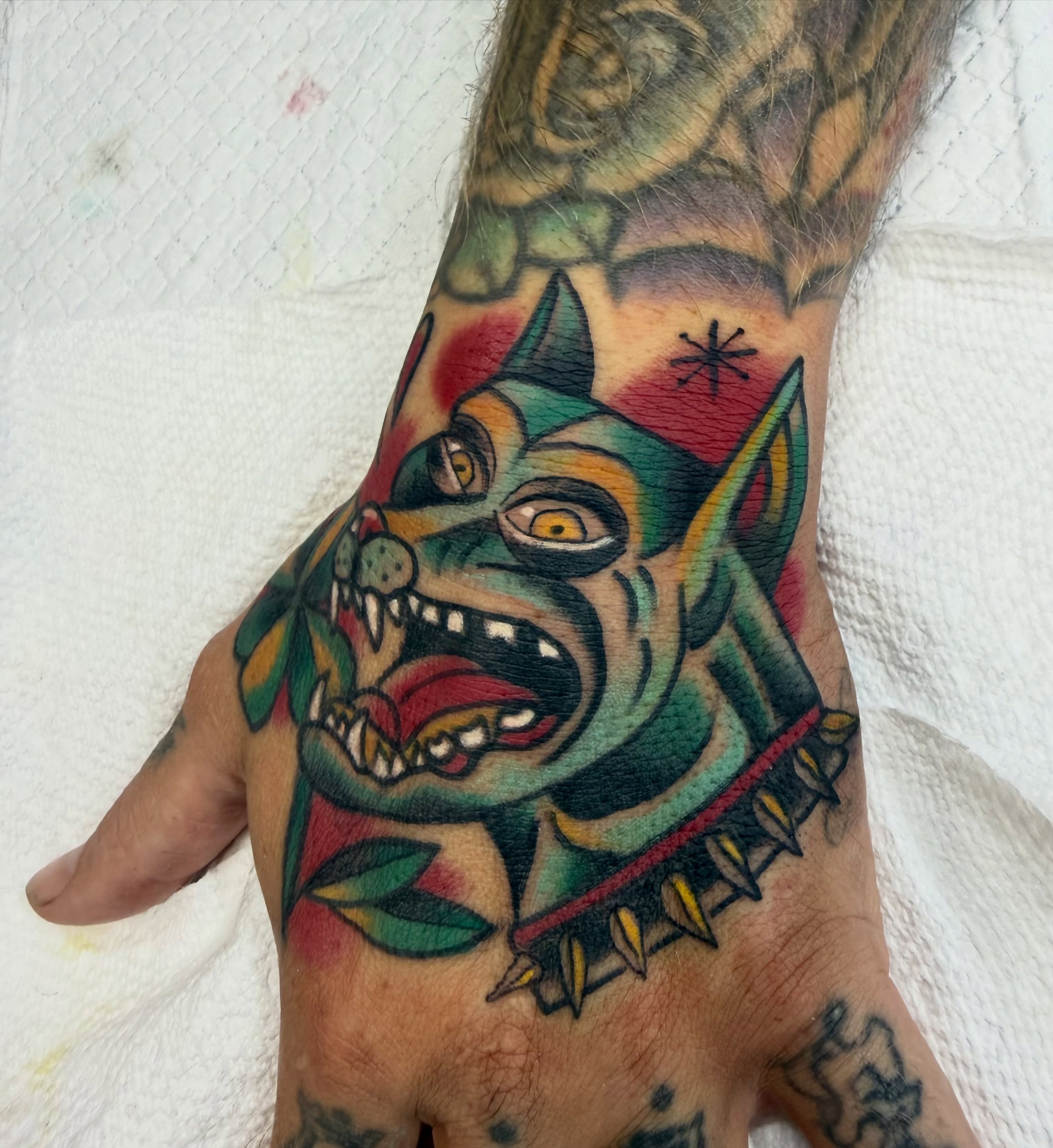 Demon dog American traditional tattoo on the hand by Shane Bonham