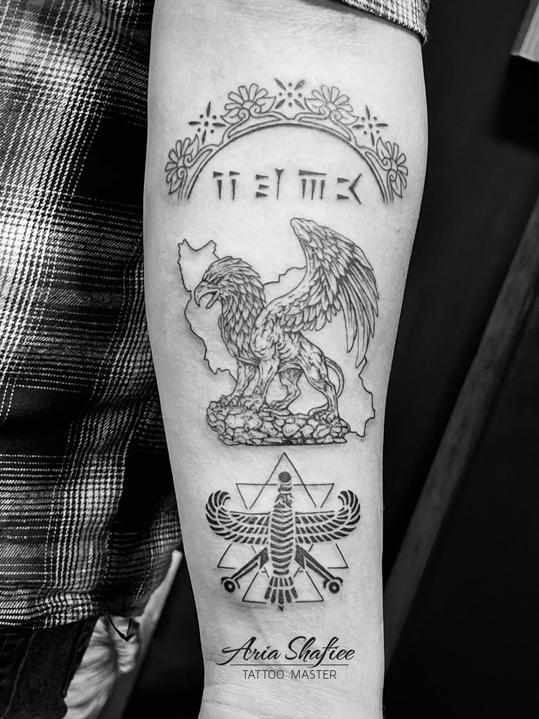 Griffin and persian symbols tribal tattoo on the forearm by Aria Shafiee
