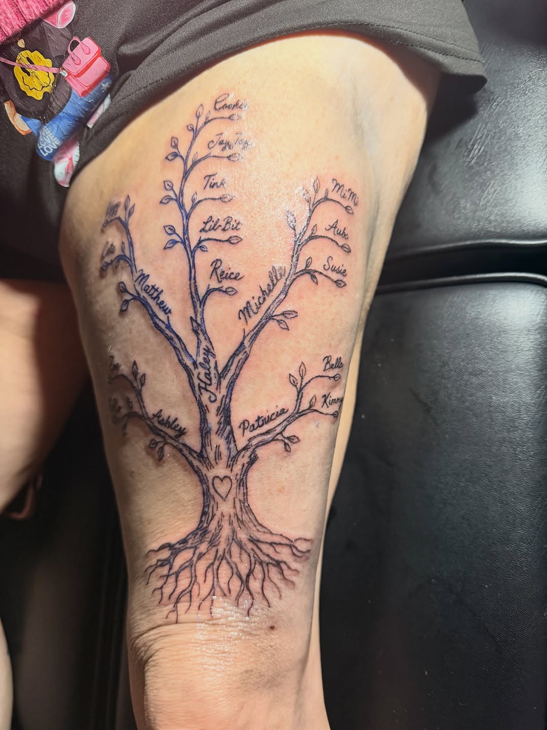 Family tree with names tattoo on the thigh by @bloodline__legacy