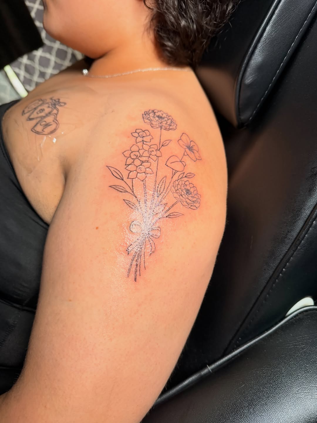 Bouquet of flowers fine line tattoo on the shoulder by @bloodline__legacy