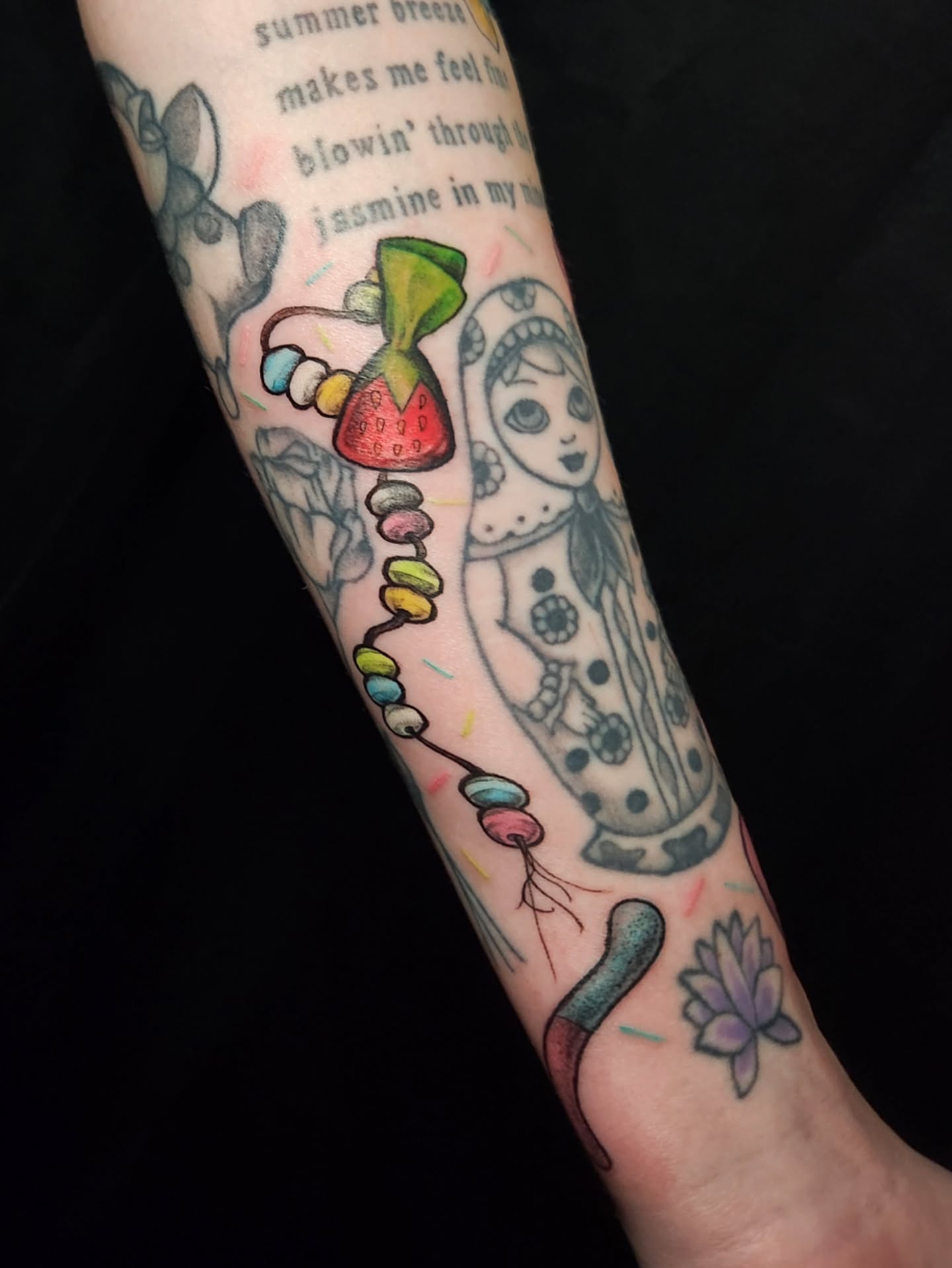 Beaded necklace new school tattoo on the forearm by Arthur Whitney Shail