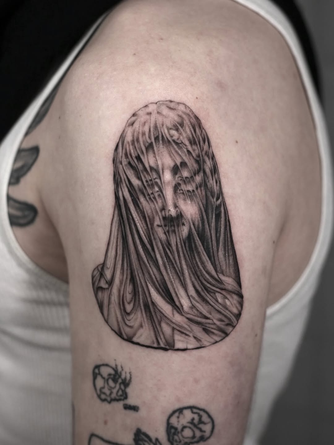 Veiled face dark art tattoo on the shoulder by Steve Franciosa