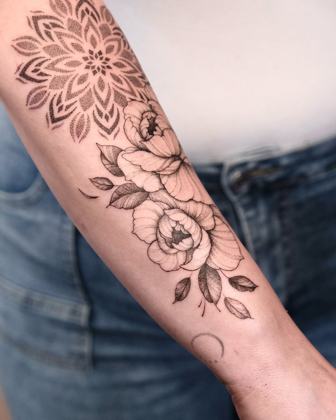 Mandala and floral arrangement dotwork tattoo on the forearm by Your tattoo Artist, New York, New York