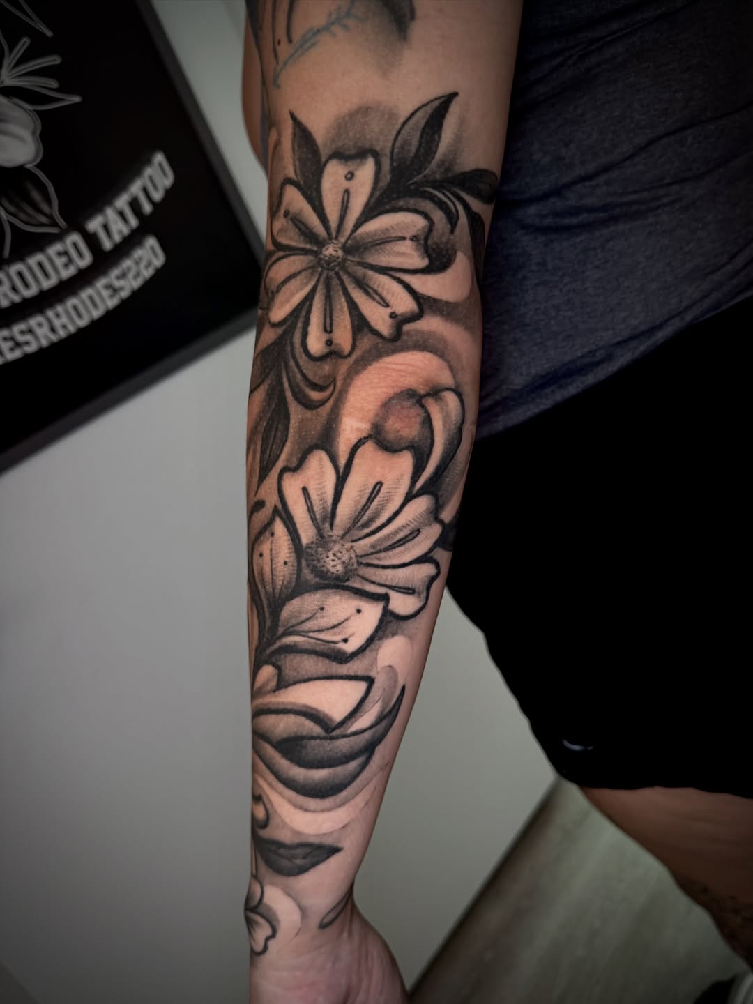 Floral sleeve with swirling background fine line tattoo on the forearm by James ⚡️ Tattoo Artist