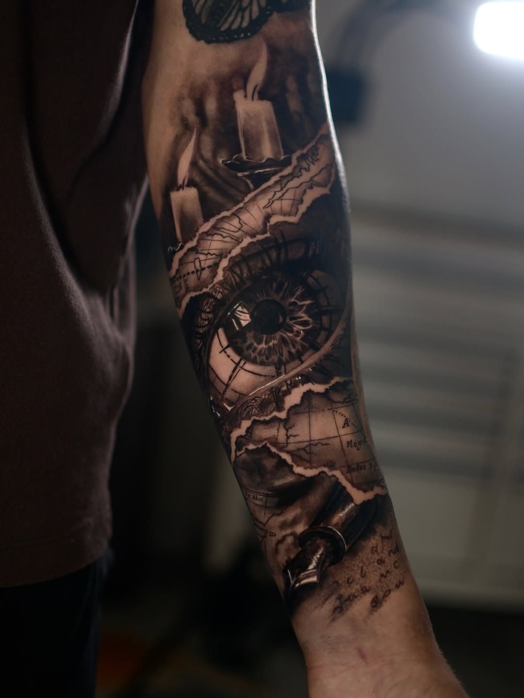 Eye, map, candles, telescope surrealism tattoo on the forearm by Joel: Boston Tattoo Artist, Boston, Massachusetts