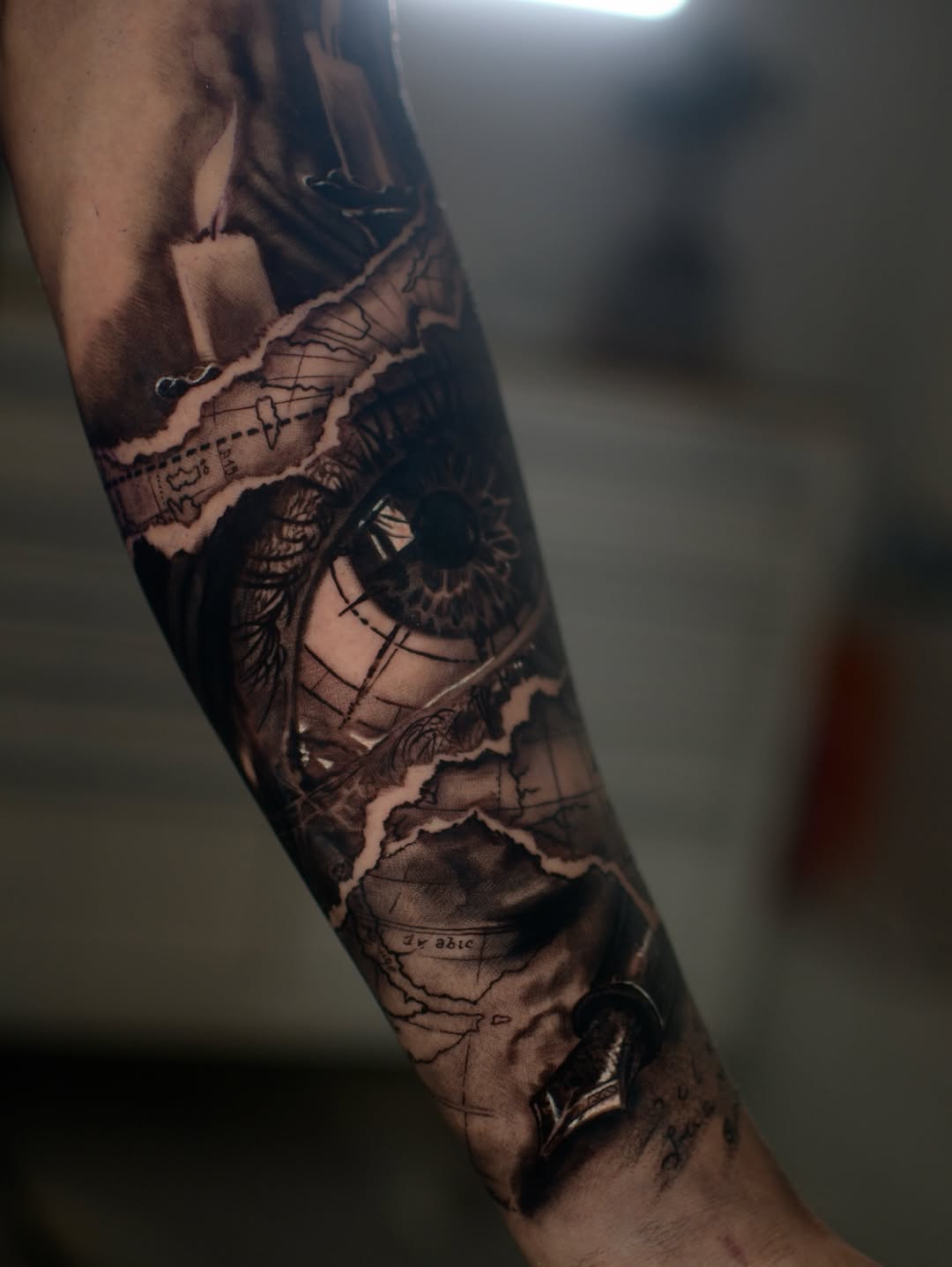 Eye and map with candle surrealism tattoo on the forearm by Joel: Boston Tattoo Artist, Boston, Massachusetts