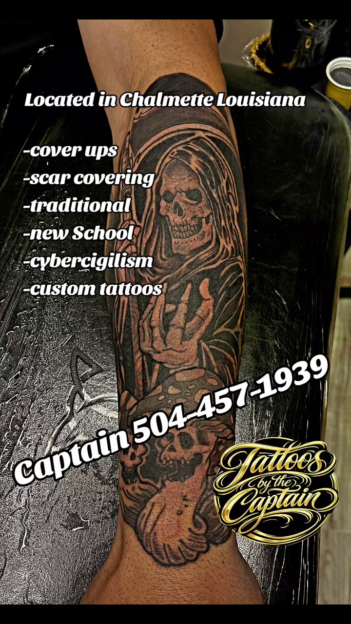 Skull and floral sleeve tattoo on the upper arm by Captain Michael Devious
