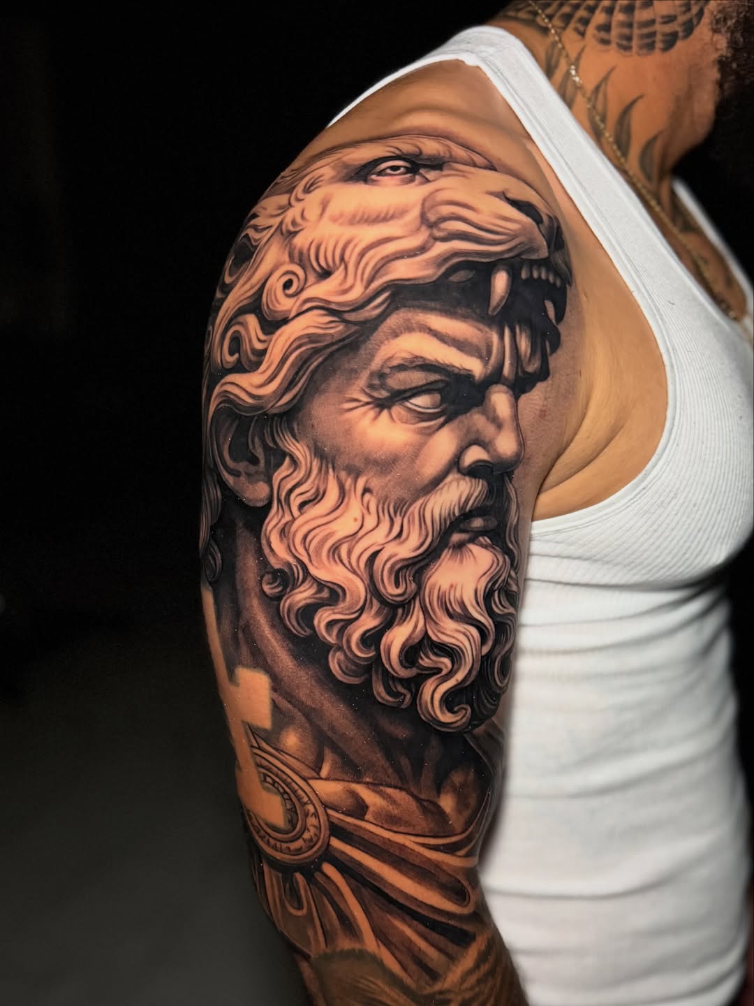 Man with lion headdress realism tattoo on the upper arm by Flames, Cerritos, California