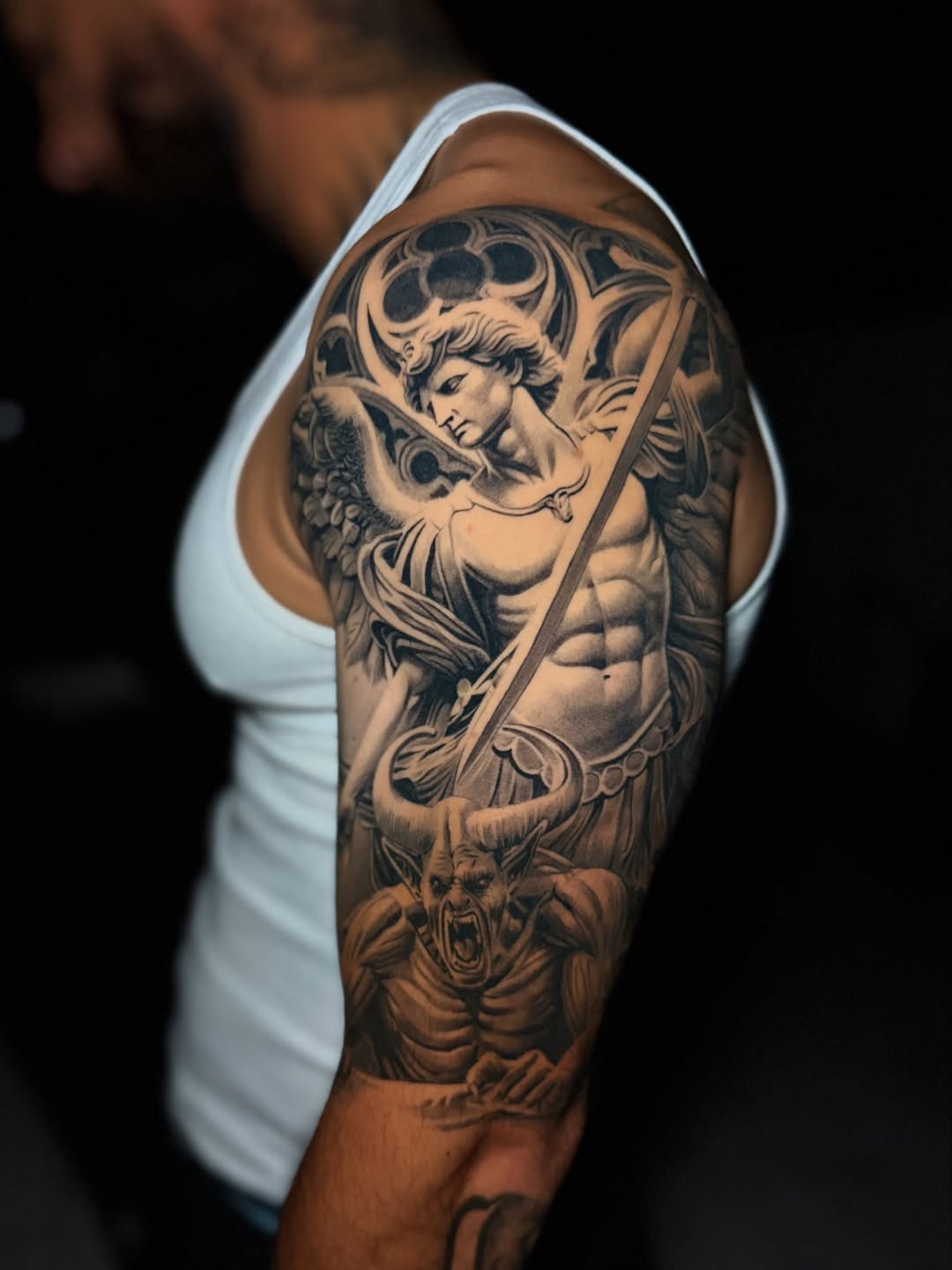 Archangel Michael and demon realism tattoo on the upper arm by Flames, Cerritos, California