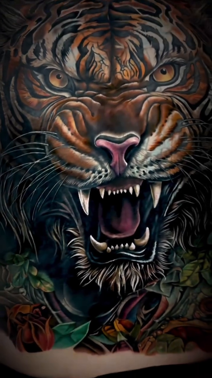 Tiger face with floral elements realism tattoo on the back by Noelin Wheeler