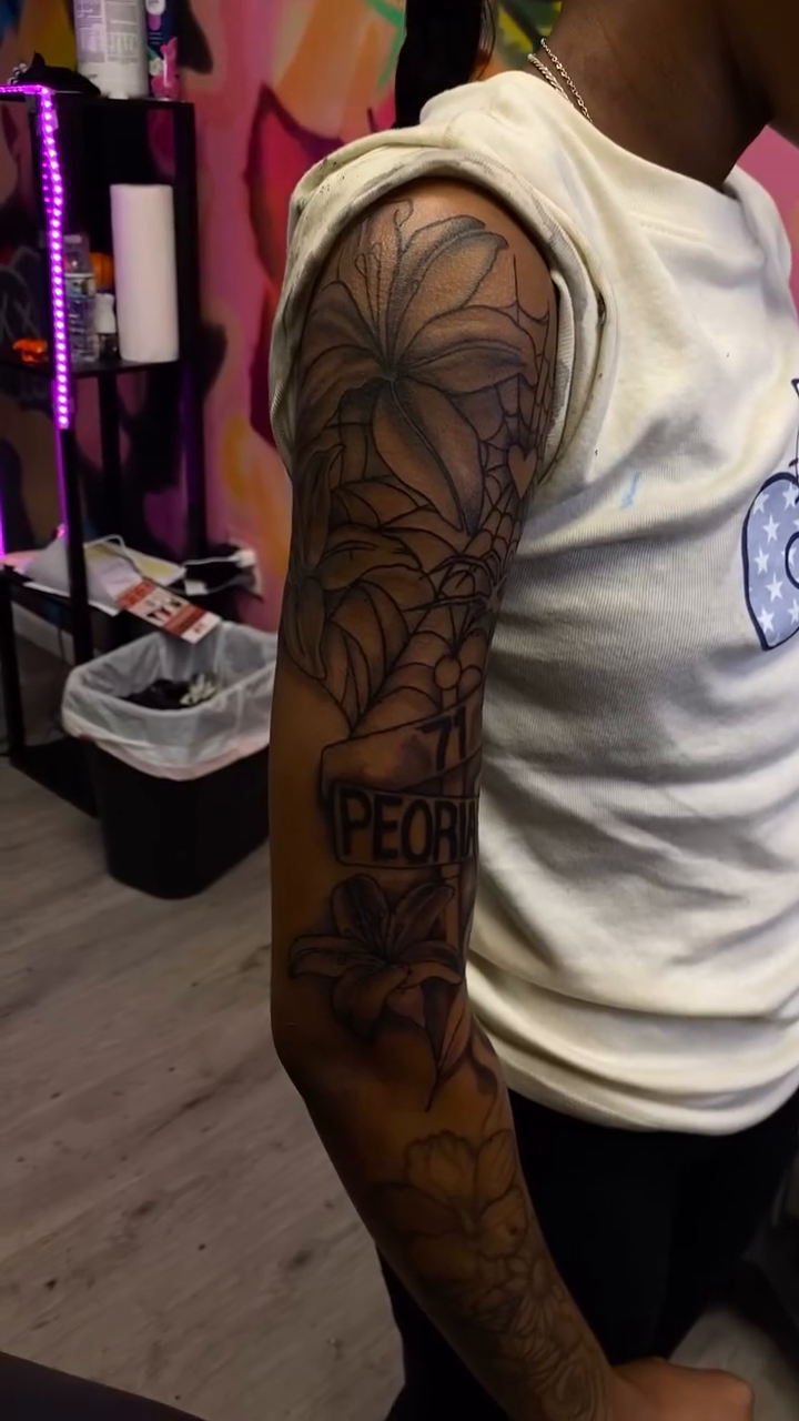 Spiderweb and floral sleeve lettering tattoo on the upper arm by Mariš¤, Chicago, Illinois