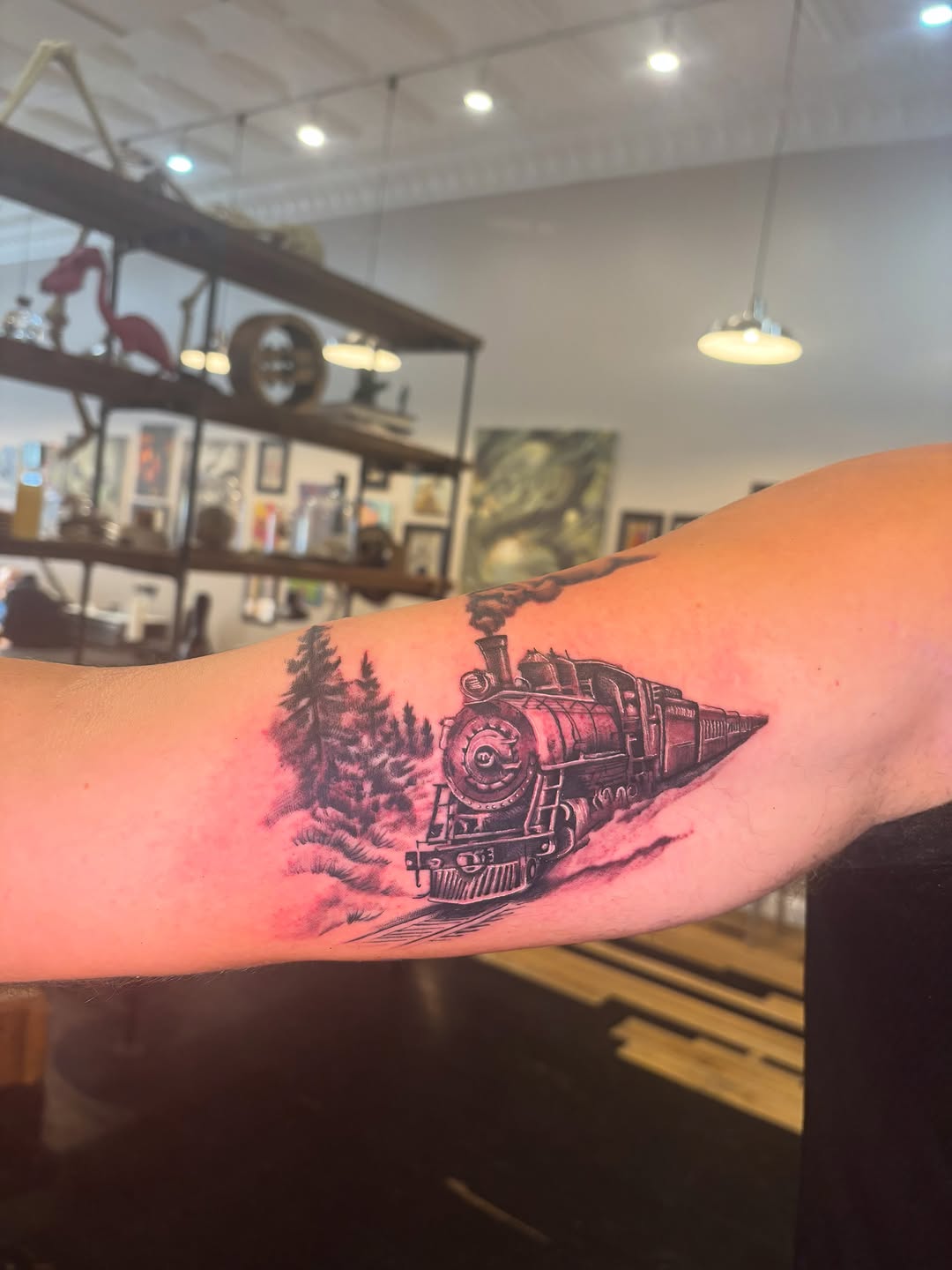 Steam train and trees tattoo on the forearm by Aubri Aunna