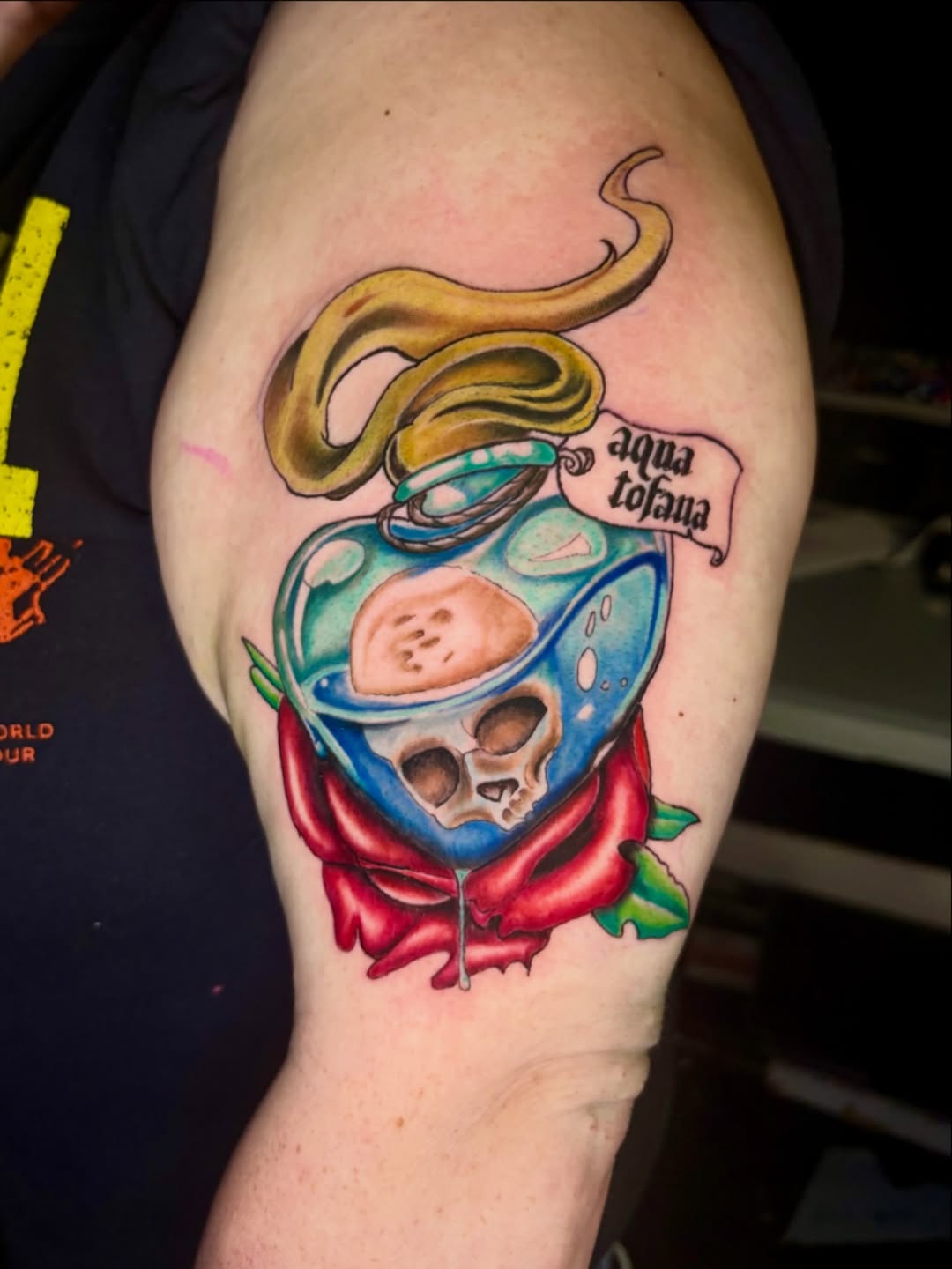 Poison bottle with skull and rose American traditional tattoo on the shoulder by Deacon Moser