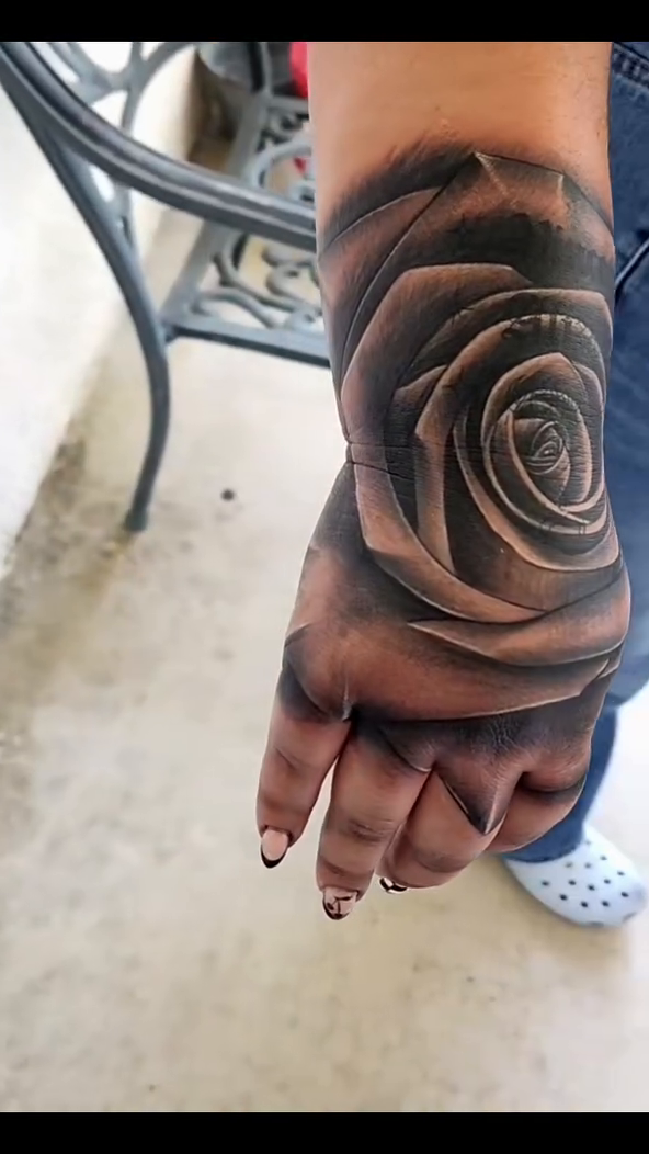 Rose tattoo on hand and wrist dotwork tattoo on the hand by @youxg_guxxz