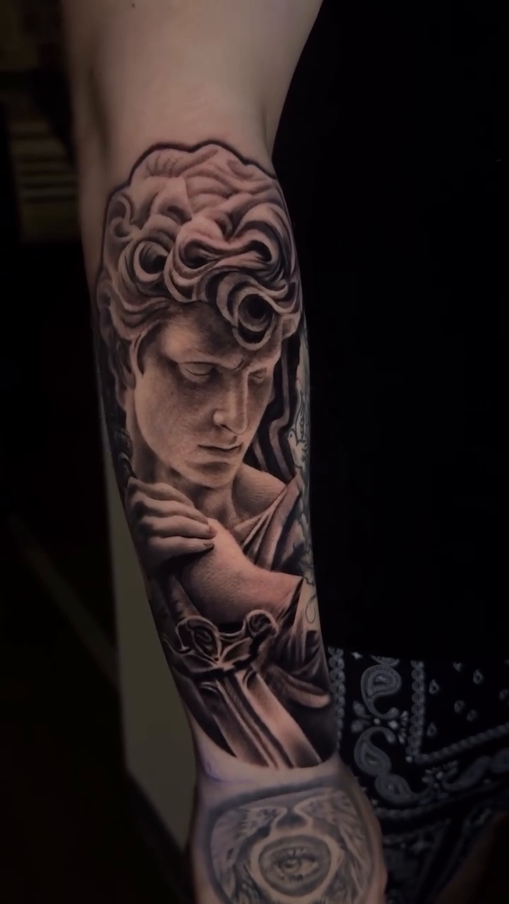 Statue of David portrait on forearm realism tattoo on the forearm by Tony Garcia