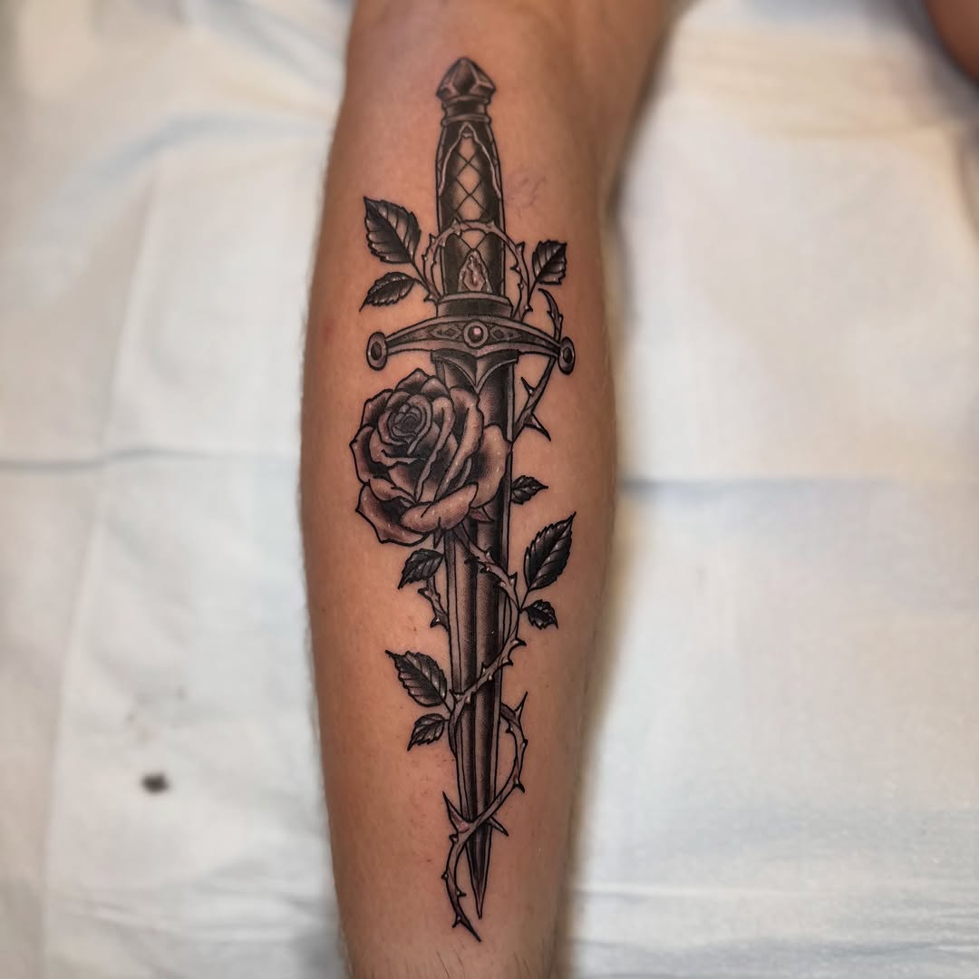 Dagger and rose American traditional tattoo on the forearm by Daniel Patrick, Jamesburg, New Jersey