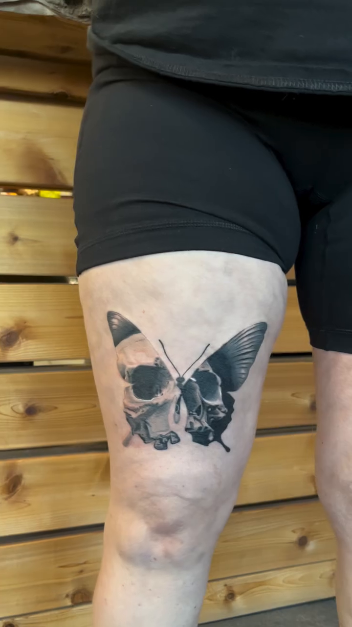 Skull and butterfly fine line tattoo on the leg by Hayes