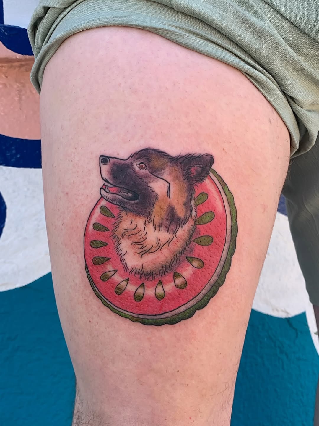 Dog in watermelon floatie realism tattoo on the thigh by CharlieBoy