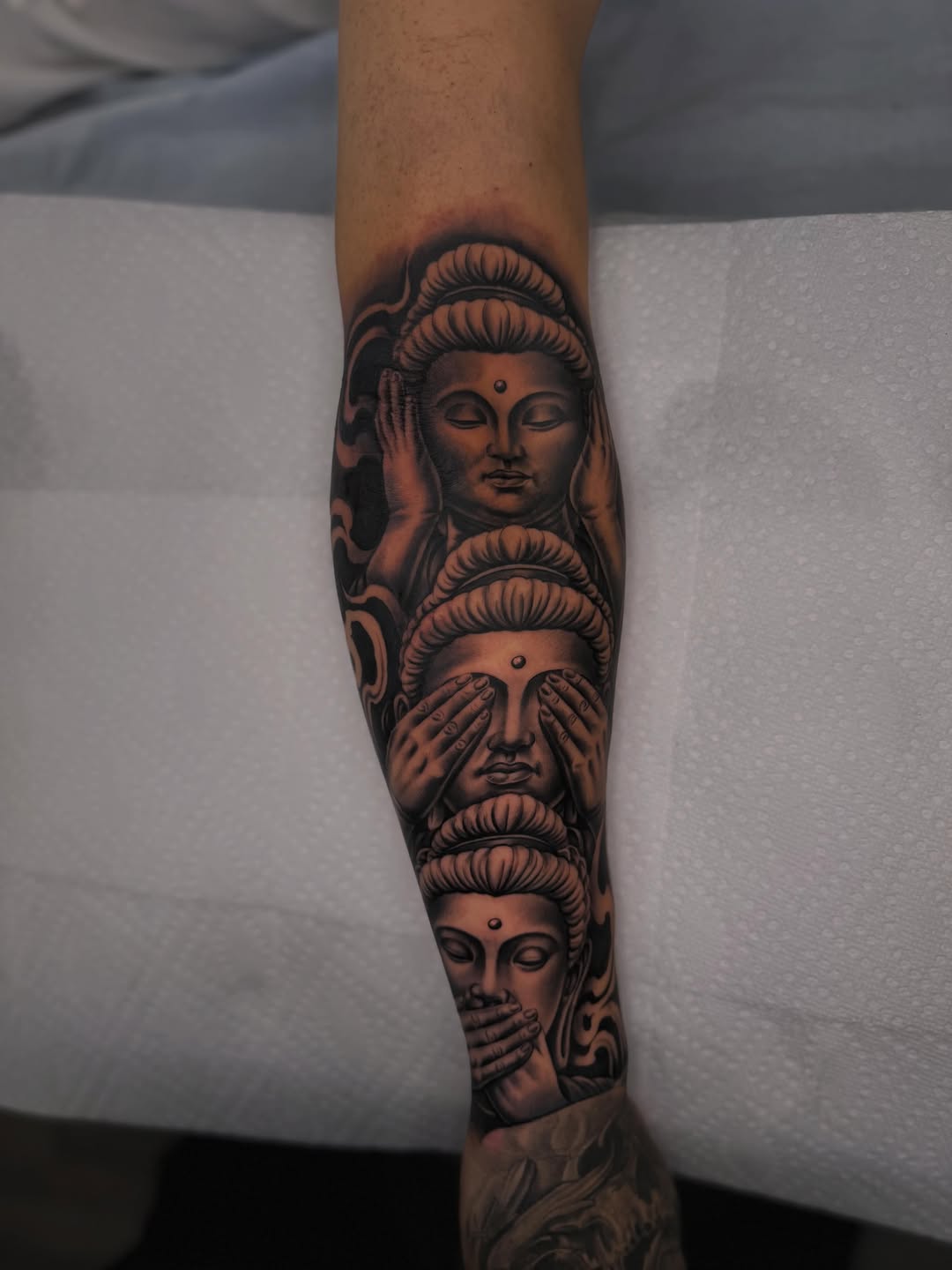 Three wise buddhas realism tattoo on the forearm by LOS