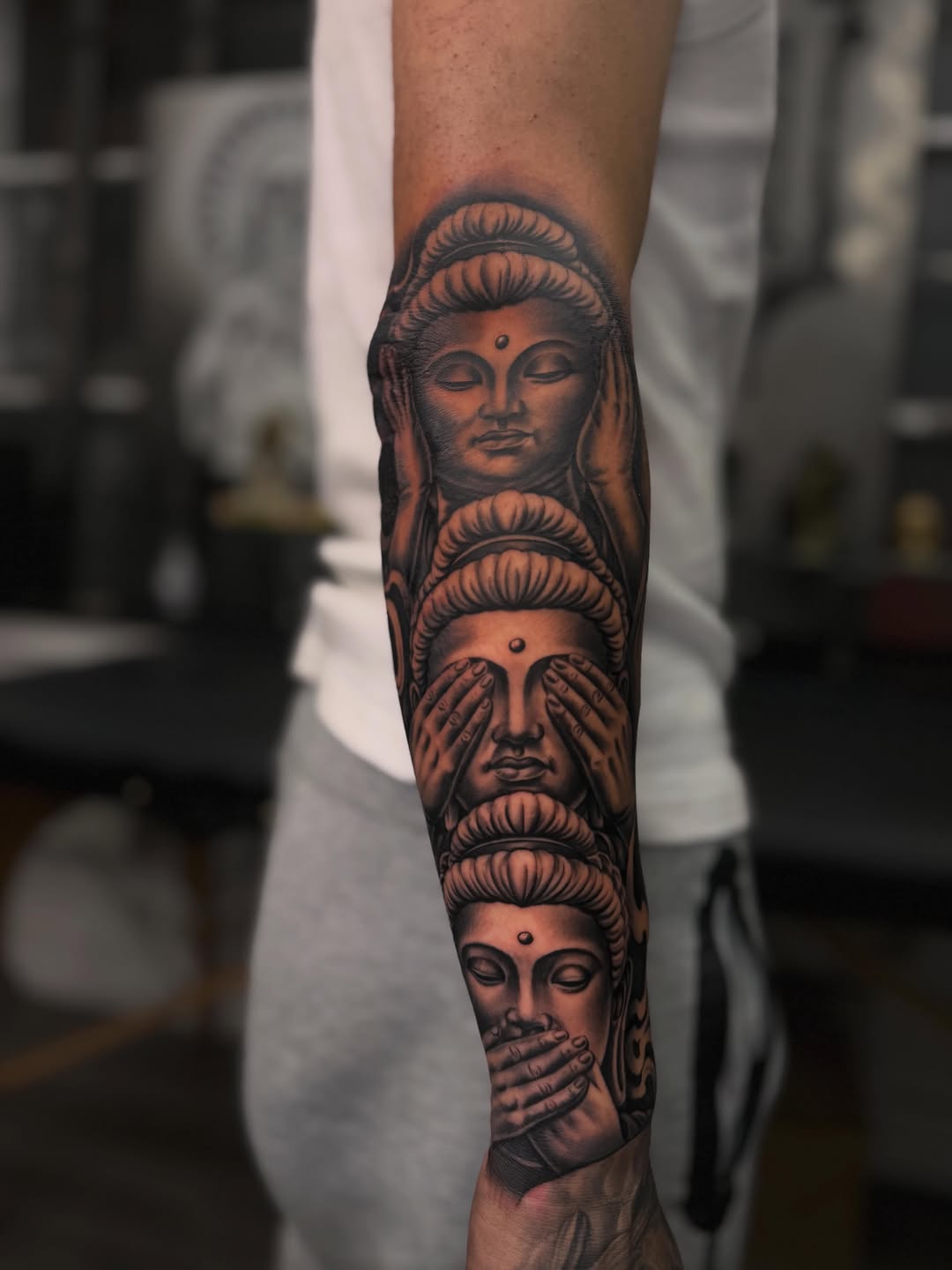 Three wise buddhas realism tattoo on the forearm by LOS