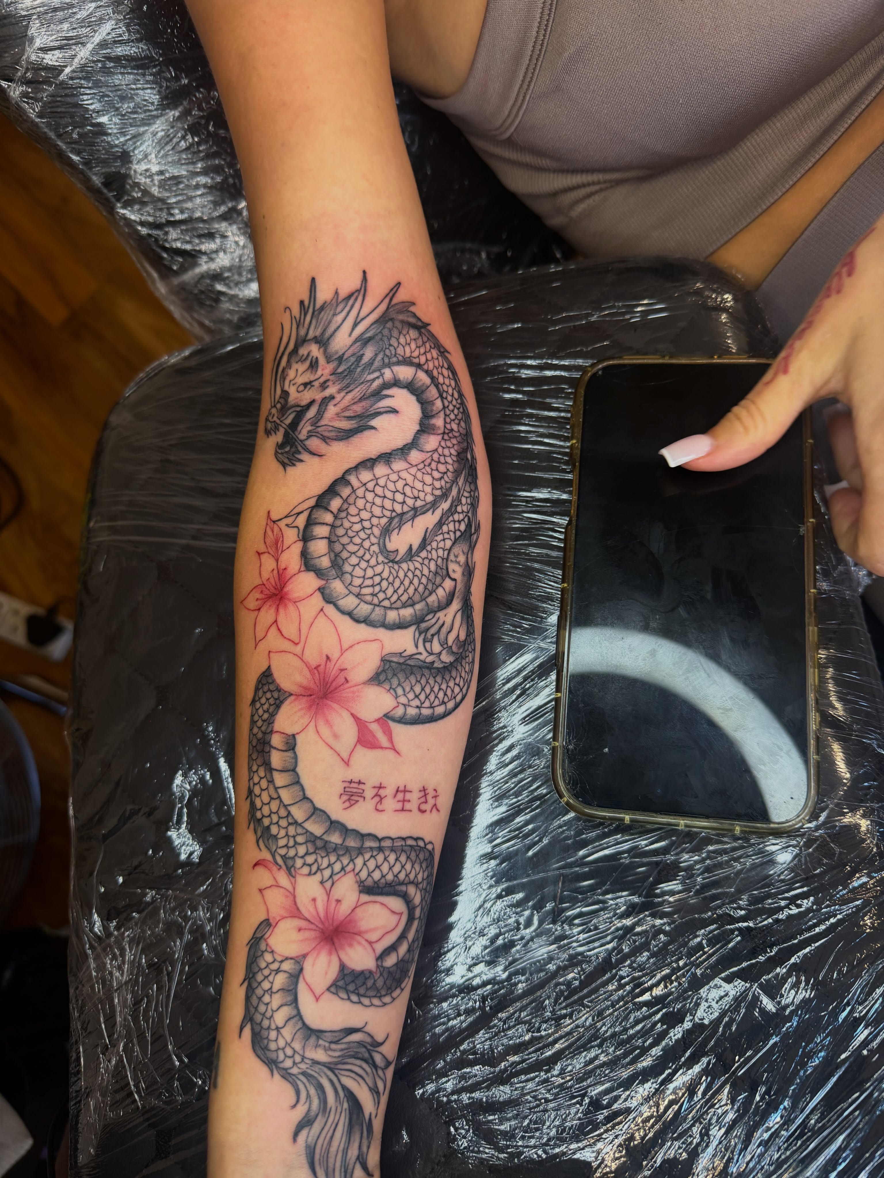 Dragon and flowers japanese irezumi tattoo on the forearm by Tcstatts