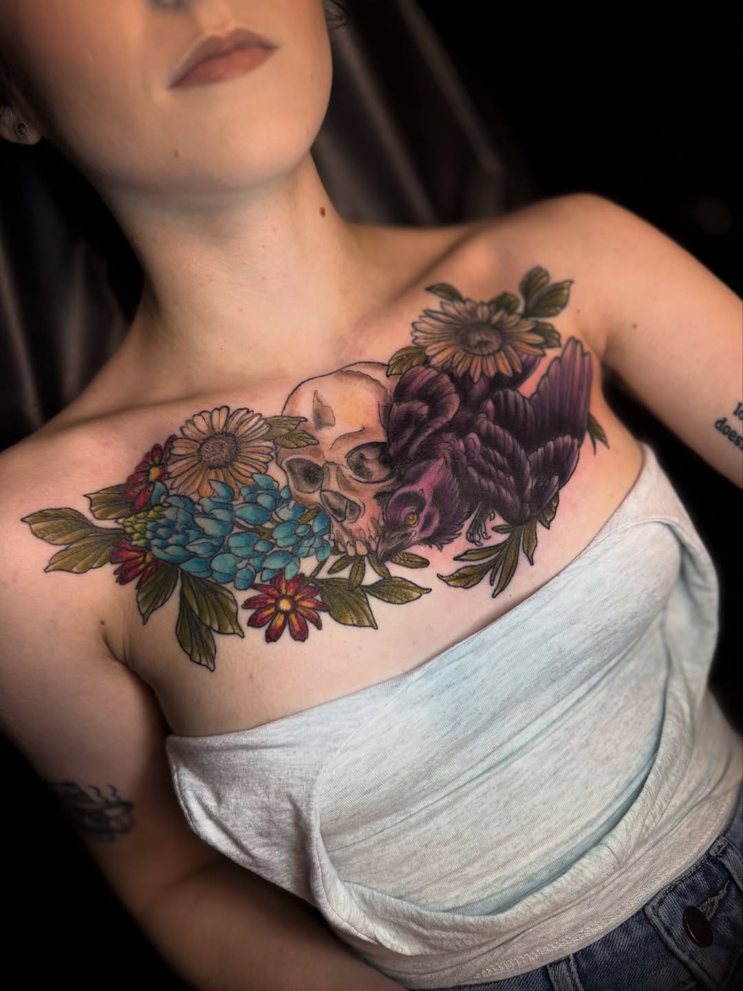 Skull and raven with flowers watercolor tattoo on the chest by Kyndall Lynn, Waxahachie, Texas