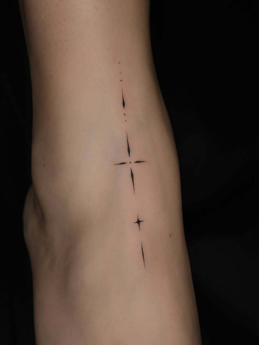 Abstract stars sketch tattoo on the forearm by Victoria