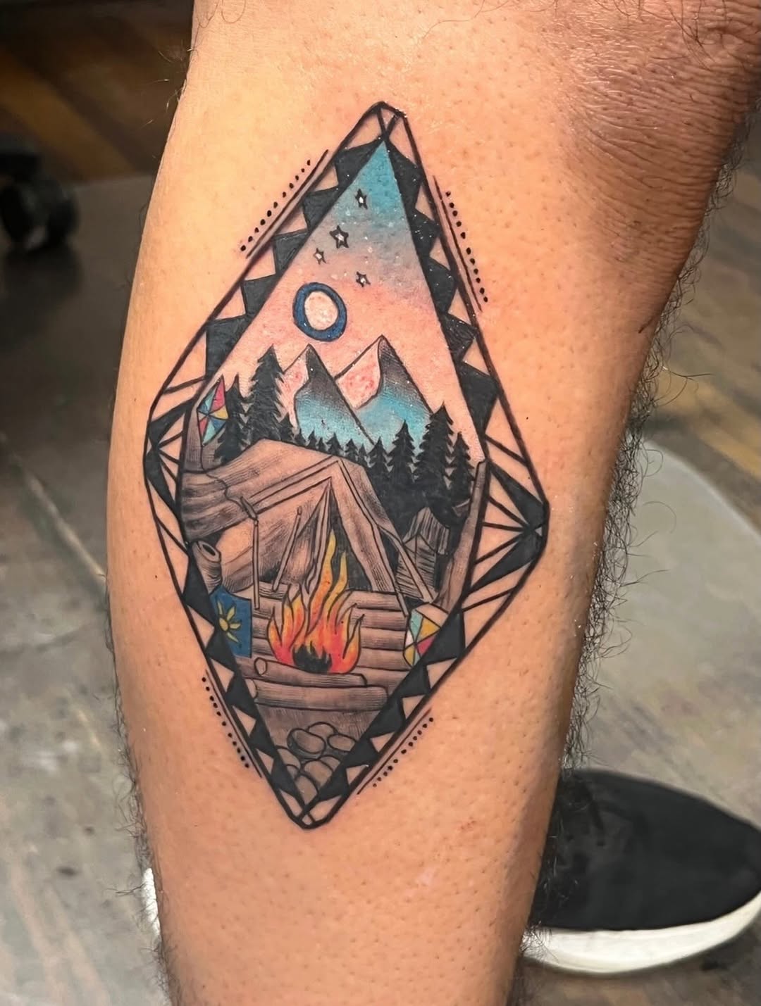 Camping scene with tent and campfire fine line tattoo on the thigh by Willi Tattoos👹