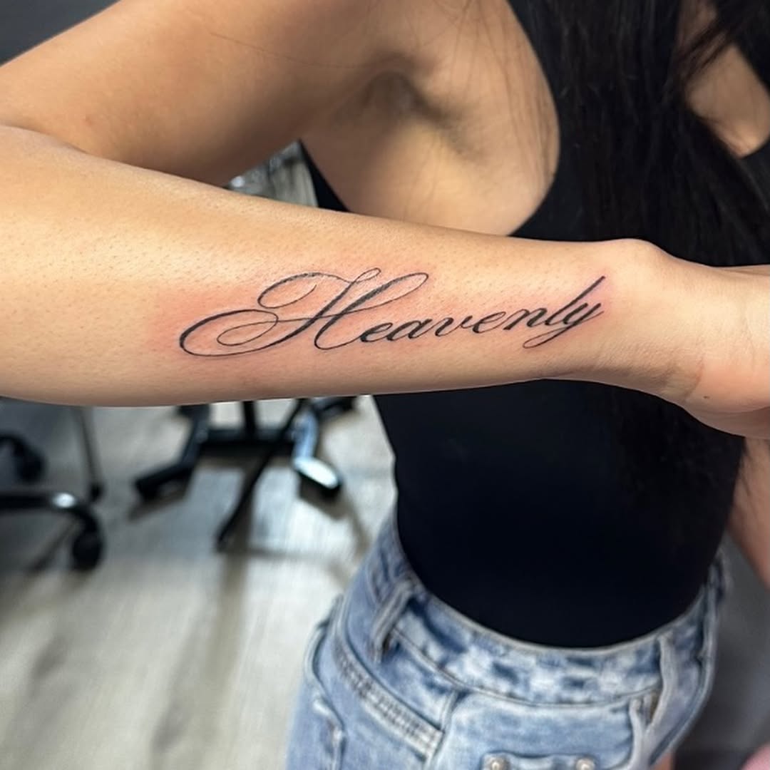 Script lettering lettering tattoo on the forearm by Lupita Ink