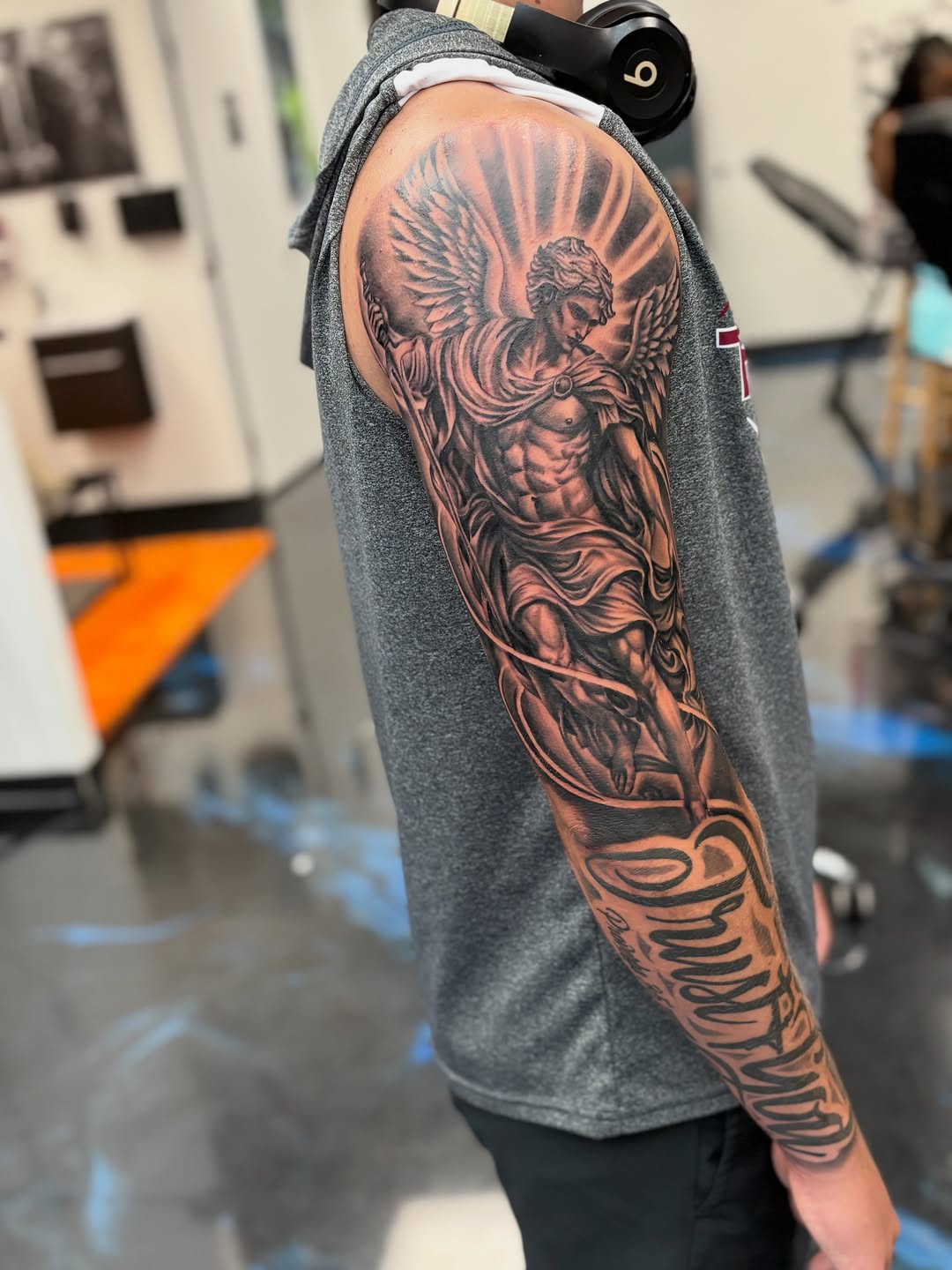Angel and script lettering realism tattoo on the forearm by Vonte Seay