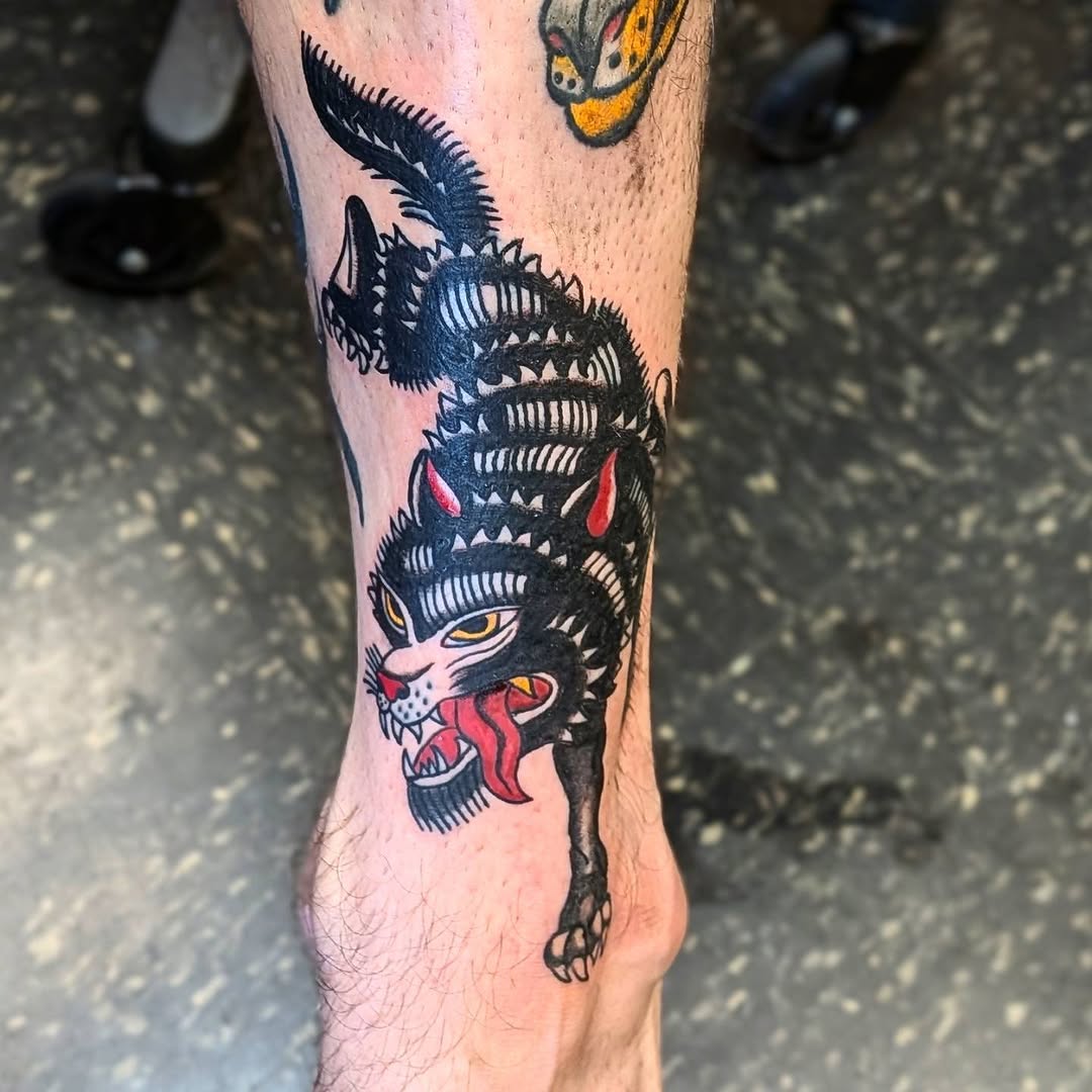 Black cat realism tattoo on the leg by Kam