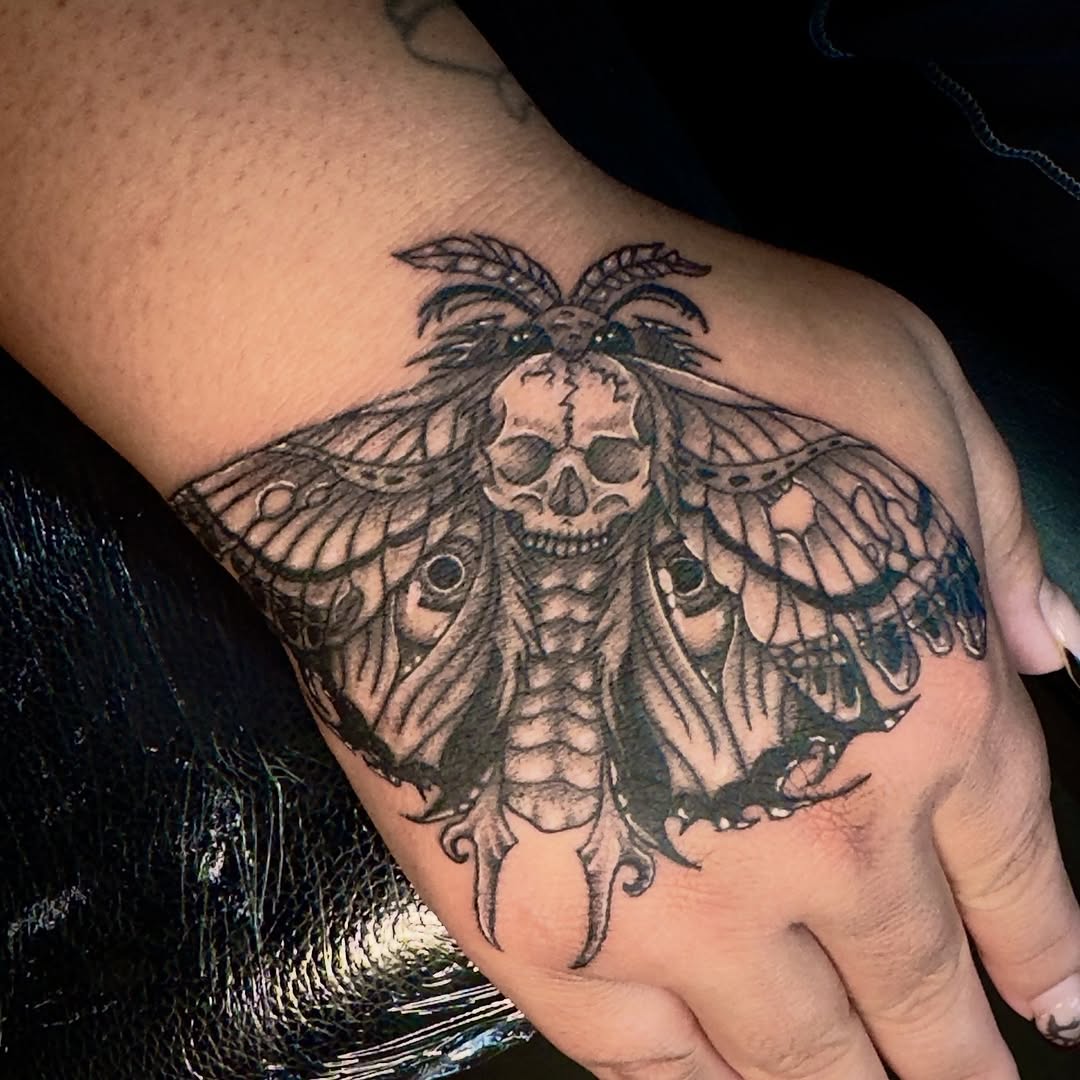 Moth with skull fine line tattoo on the forearm by Seth Christianson