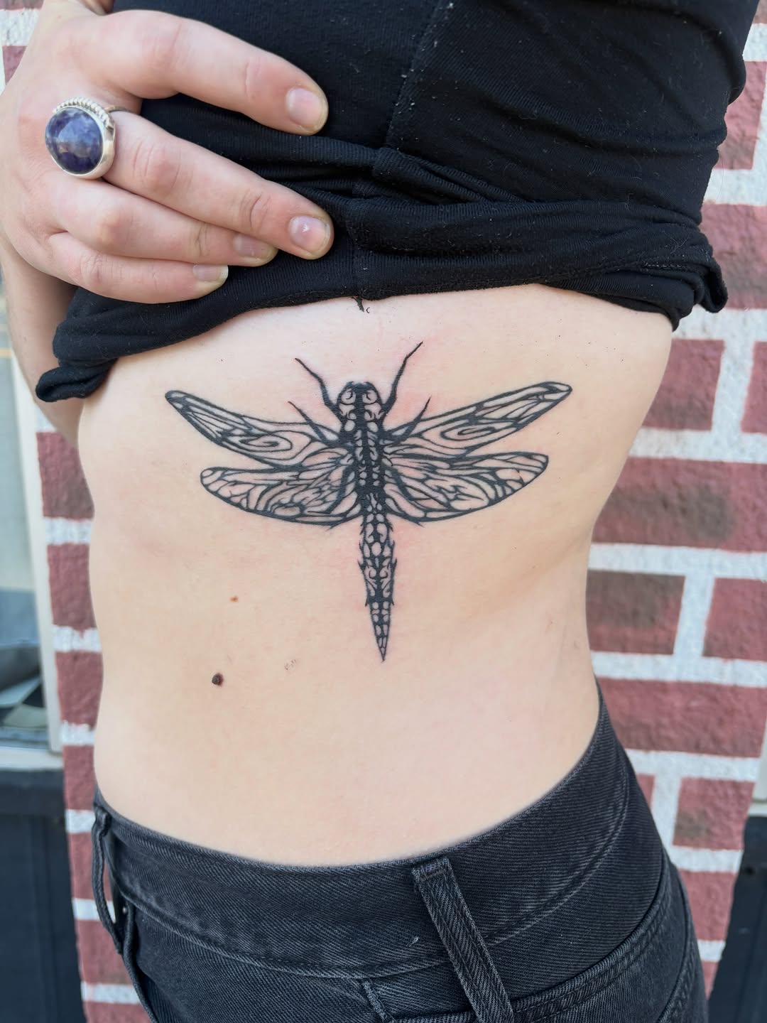 Dragonfly fine line tattoo on the ribs by izzy solae